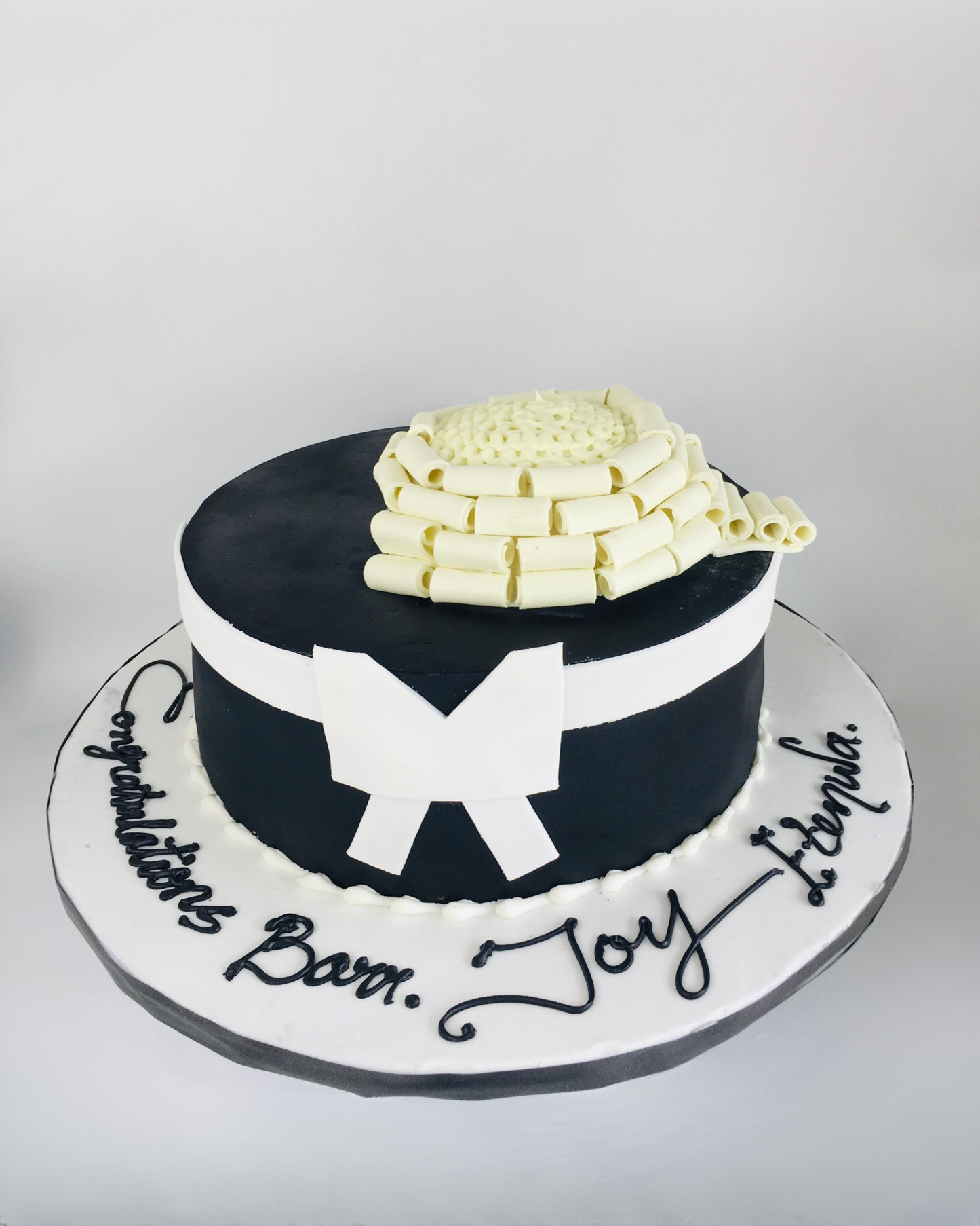 Black and white cake with decorative elements on a plain background