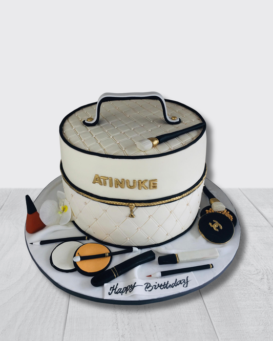 Cake designed like a makeup bag with cosmetic items on a white background