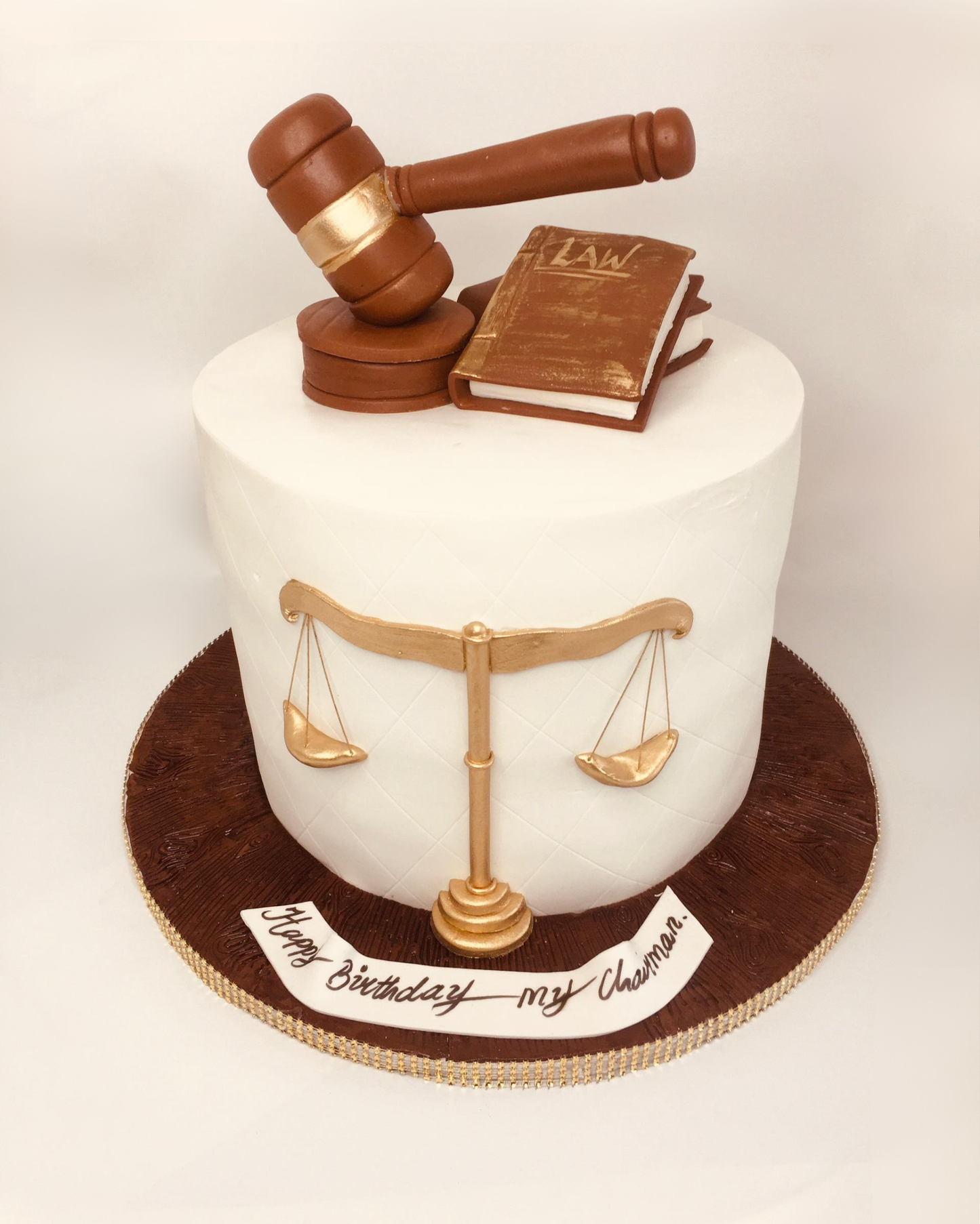 Cake with a gavel and book of law on top, featuring the scales of justice.