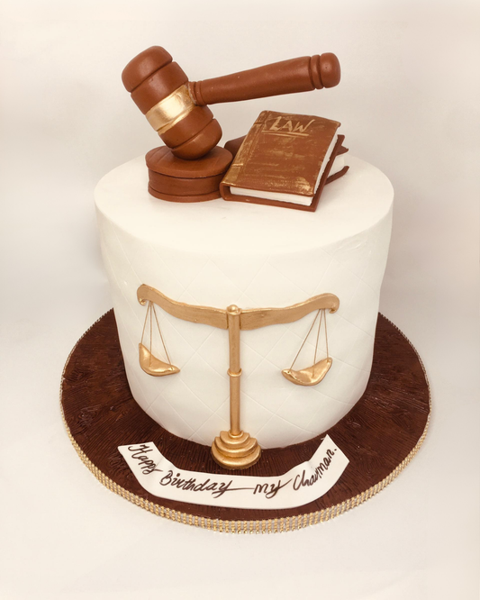 Cake with a gavel and book of law on top, featuring the scales of justice.