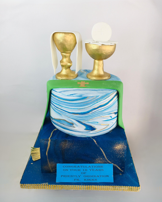 Priestly Decorative cake with gold goblets and blue and white marbled design on a white background