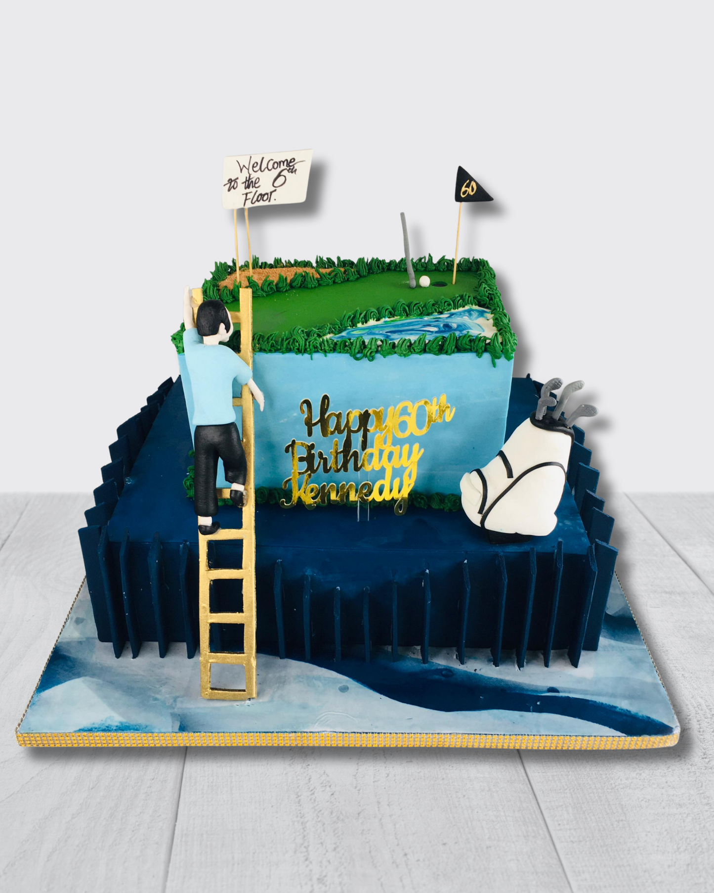 Golf-themed birthday cake with golfer, golf club, and decorative elements on a white background