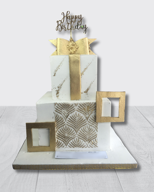 Decorative birthday card with gold and white design elements on a white background
