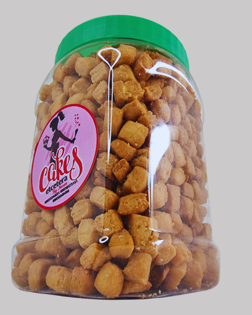 Jar of chin chin with a 'Cakes' label on a gray background