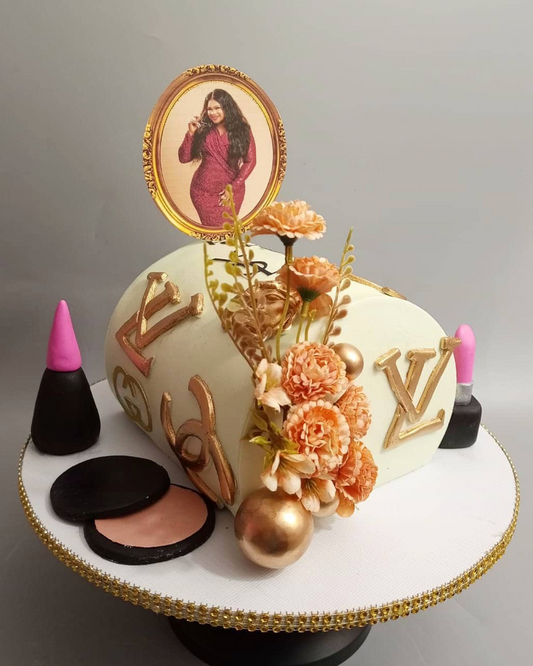 Makeup-themed cake with decorative elements and a portrait on top