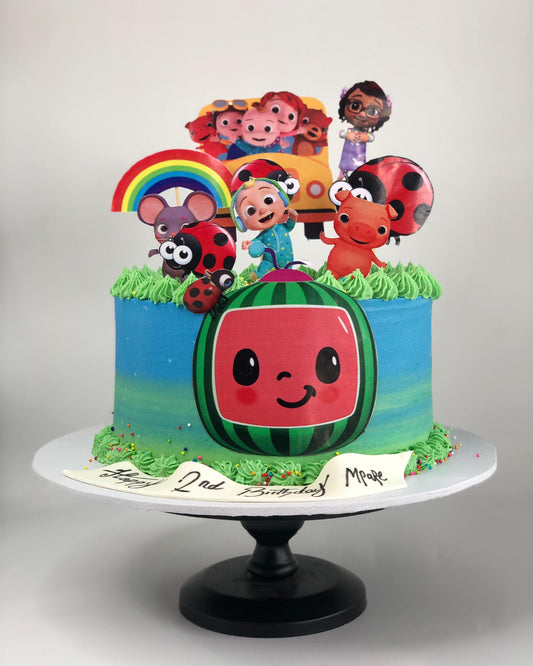 Cake with cartoon characters and a watermelon design on a white background