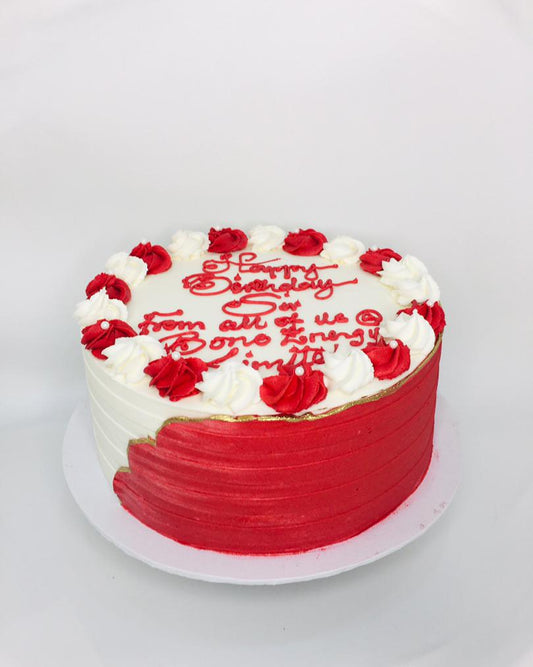 Red and white birthday cake with red roses on a white background