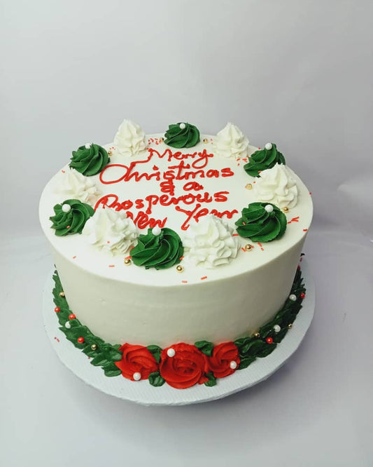 White cake with red and green decorations on a white background