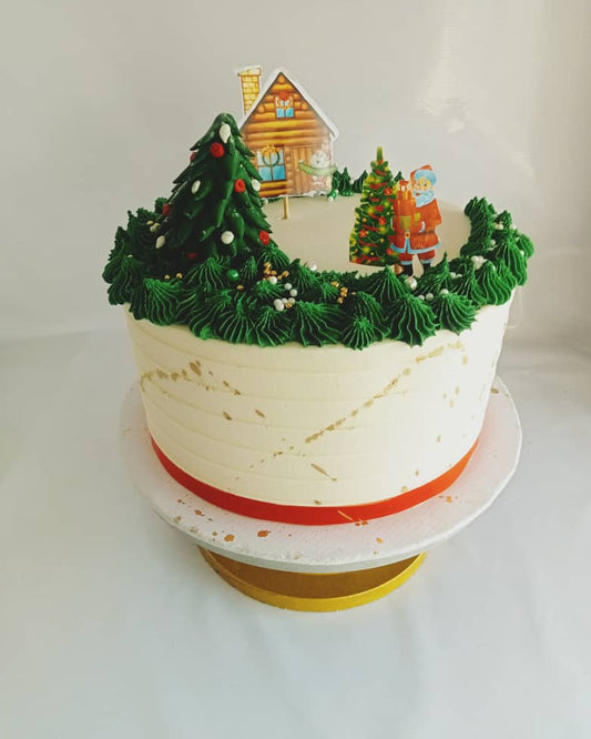 Decorative cake with Christmas tree and house decorations on a white background