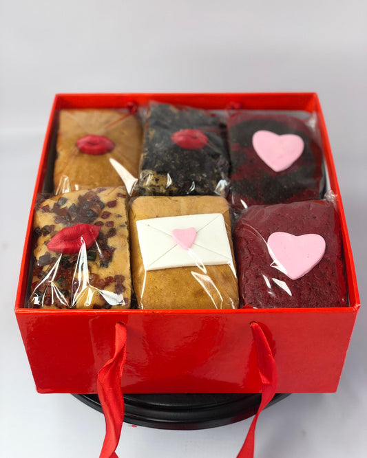 Red gift box with various types of love-themed mini loafs
